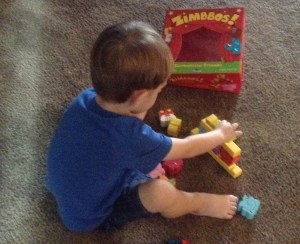 Tahoe can't resist a chance to play this math game by himself. It is best to let children play with the manipulatives for awhile first before teaching them the rules of the game.