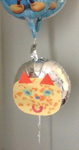 The construction paper weighs down one helium balloon too much. I had to tie two other helium balloons to the one with the construction paper face to keep it floating.